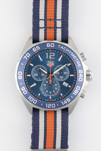 TAG Heuer Formula 1 Gulf Edition chronograph with a blue, white, and orange NATO strap displayed on a white background.