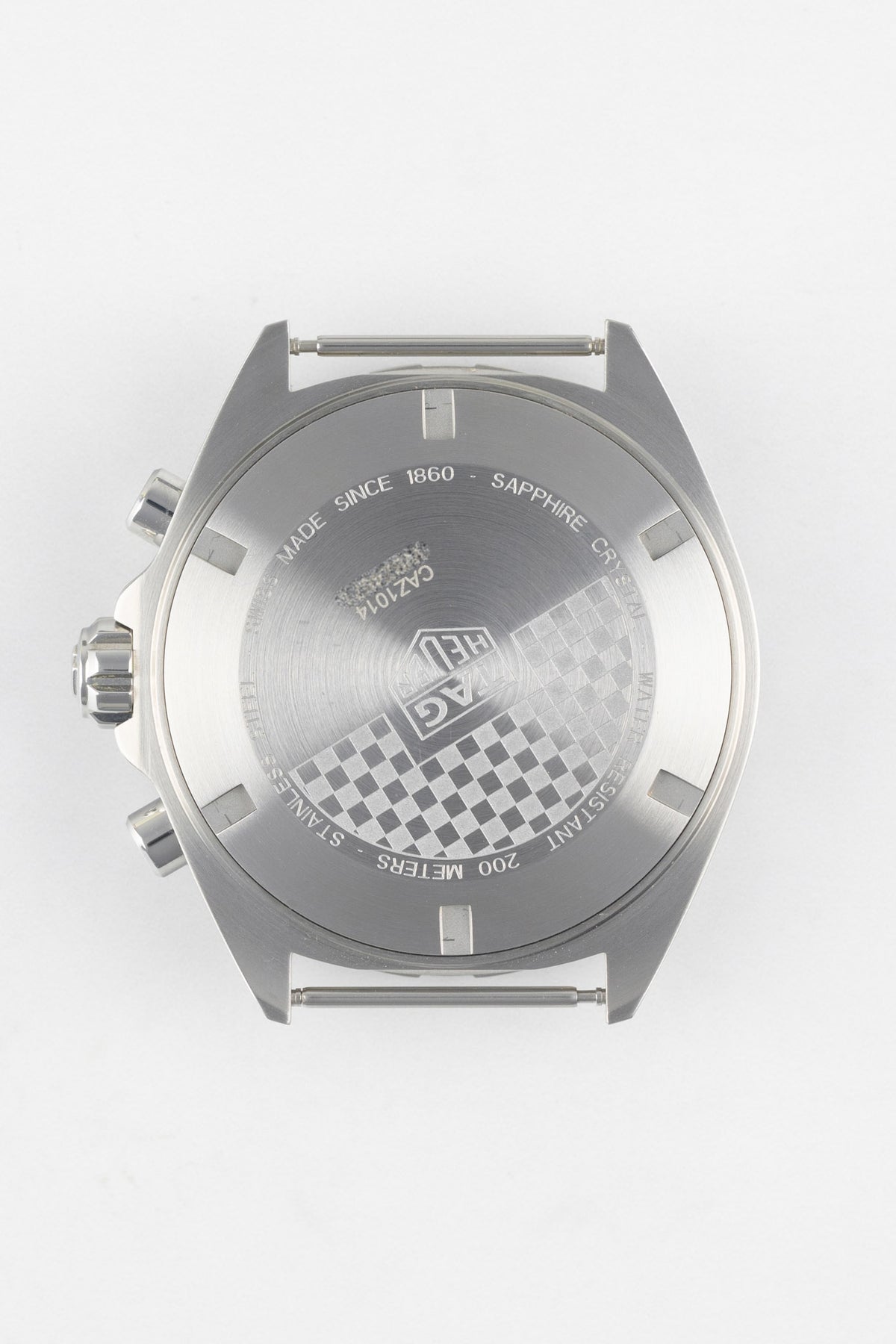 Premium TAG Heuer Formula 1 Gulf Edition chronograph watch featuring a brushed stainless steel caseback with engraved chequered flag detailing, TAG Heuer shield logo, sapphire crystal, 200-metre water resistance, and chronograph construction. Detailed rear-view product photograph showcasing Swiss craftsmanship, motorsport-inspired design, robust durability, and precision engineering, making it ideal for collectors, racing enthusiasts, and everyday sports-watch wear.