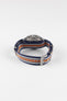 Premium TAG Heuer Formula 1 Gulf Edition chronograph watch featuring a stainless steel case, chronograph pushers, and a blue, white, and orange striped NATO-style fabric strap inspired by iconic Gulf racing colours. Detailed rear-angle product photograph showcasing the signed TAG Heuer buckle, durable woven strap construction, stainless steel hardware, exceptional comfort, and distinctive motorsport-inspired styling. Ideal for collectors, racing enthusiasts, and everyday wear.