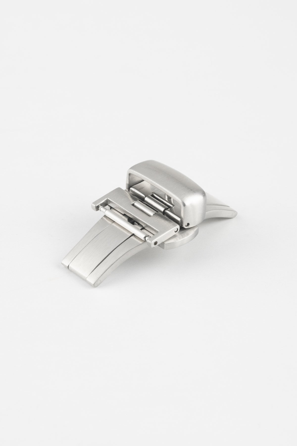 Brushed stainless steel butterfly deployment clasp displayed partially open on a clean white background. The watch strap clasp features a dual-folding mechanism, integrated push-button release system, and curved folding blades designed to provide a secure and comfortable closure for leather watch straps while reducing wear during fastening and removal.
