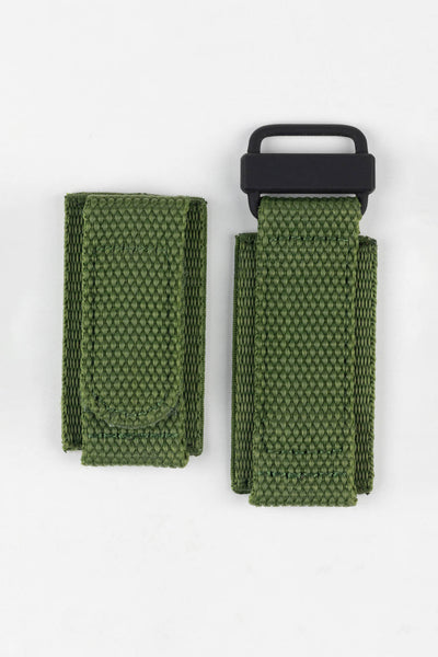 Olive green hook-and-loop watch strap with a woven nylon construction and black attachment loop, displayed on a white background.