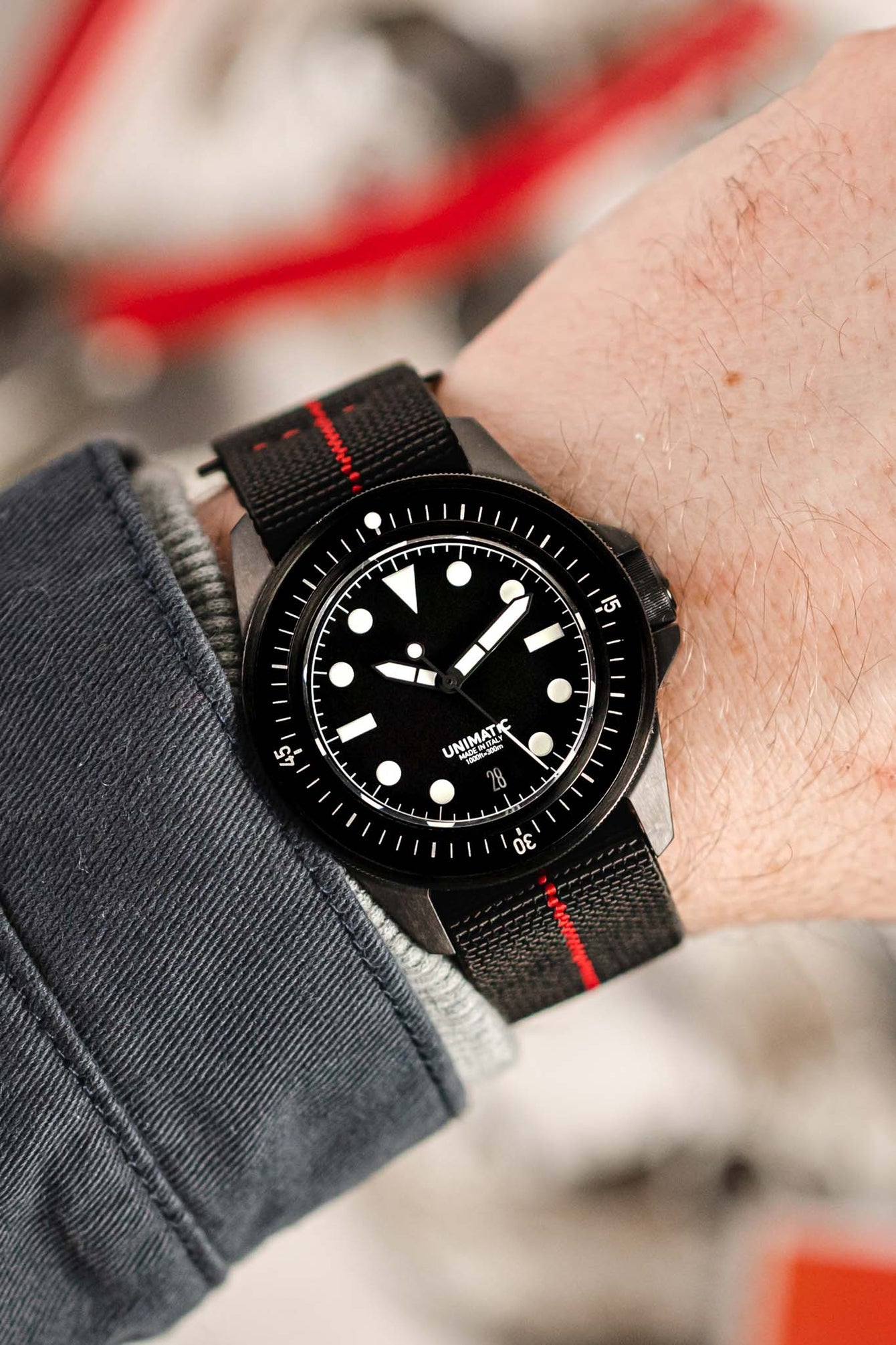 Unimatic Modello Uno U1-FDN Watch in Matte Black fitted with Erika's Originals Black Ops strap in full black with Red centerline worn on wrist