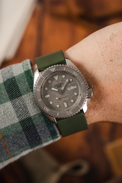 Bonetto Cinturini Dark Green 270 fitted to Seiko 5 Sports SRPG61K1 cement dial on wrist with flannel shirt