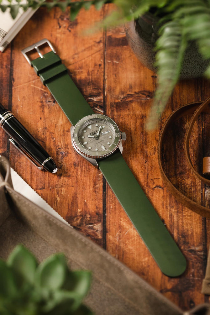 Bonetto Cinturini 270 Dark Green fitted to Seiko 5 Sports SRPG61K1 cement dial flat on wooden table