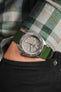 Bonetto Cinturini 270 Dark Green watch strap and Seiko 5 Sports SRPG61K1 cement dial on wrist with hand in pocket