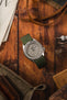 Seiko 5 Sports SRPG61K1 cement dial with Bonetto Cinturini 270 Navy Blue curved on Wooden Table