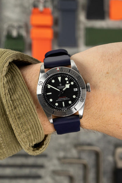 Tudor Black Bay Steel M79730-0005 with Bonetto Cinturini 317 rubber watch strap in dark blue on wrist with green jacket 