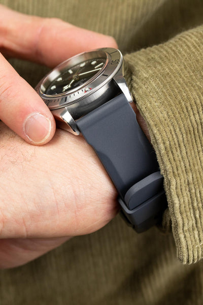 Bonetto Cinturini 317 rubber watch strap in dark grey fitted to Tudor Black Bay Steel M79730-0005 on wrist with green shirt