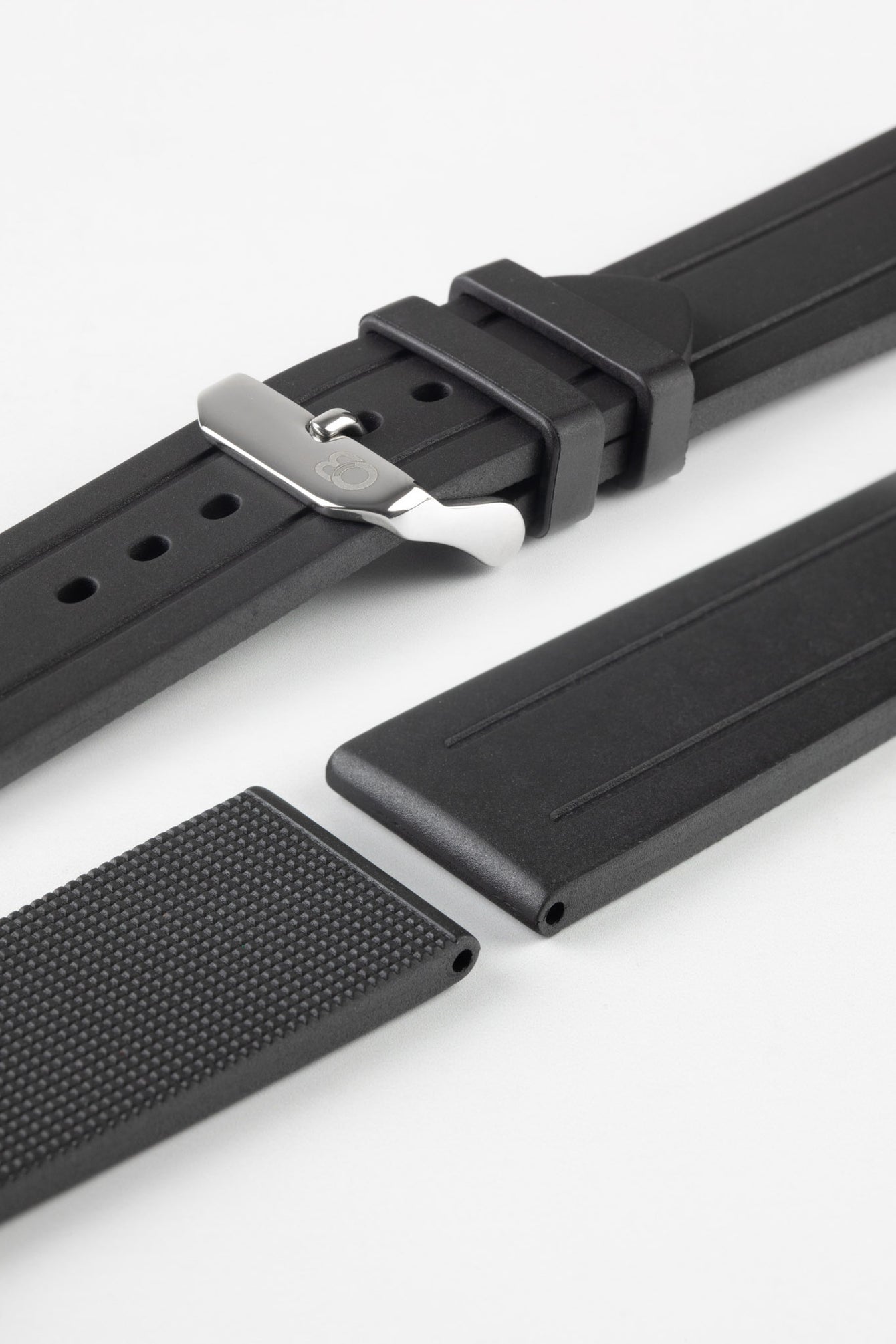 Lug and buckle end of black bonetto cinturini 319 rubber watch strap with polished stainless steel logo embossed buckle