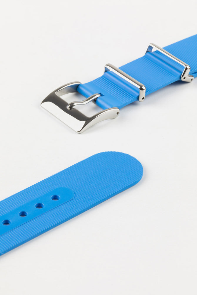 Polished stainless steel buckle and adjustment holes of bonetto centurini 328 one piece rubber watch strap in azure light blue