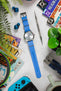 Seiko Presage Cocktail Skydiving SRPB43J1 with Azure light blue bonetto cinturini 328 rubber one piece strap flat on table by earphone and spring bar tool