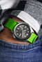 Seiko 5 Sports Anthracite Dial SRPE51K1 fitted with lime green Bonetto Cinturini 328 rubber watch strap worn on wrist in hand of pocket 