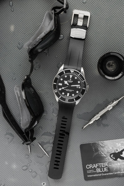 Tudor Pelagos Black dial and bezel fitted with crafter black TD02 Rubber watch strap with brushed stainless steel buckle lying flat 