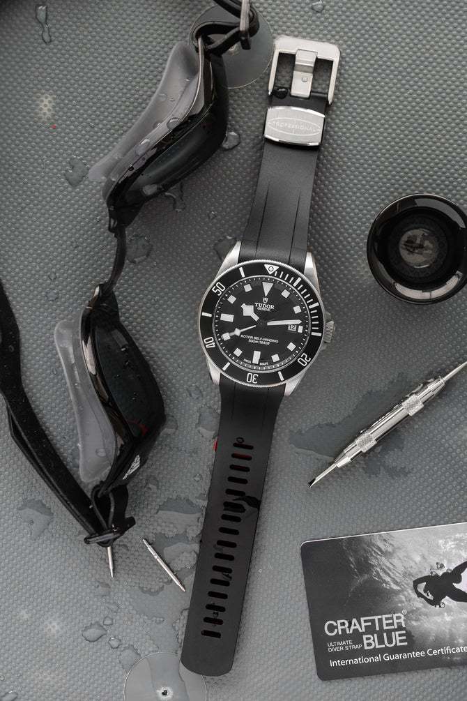 Tudor Pelagos Black dial and bezel fitted with crafter black TD02 Rubber watch strap with brushed stainless steel buckle lying flat