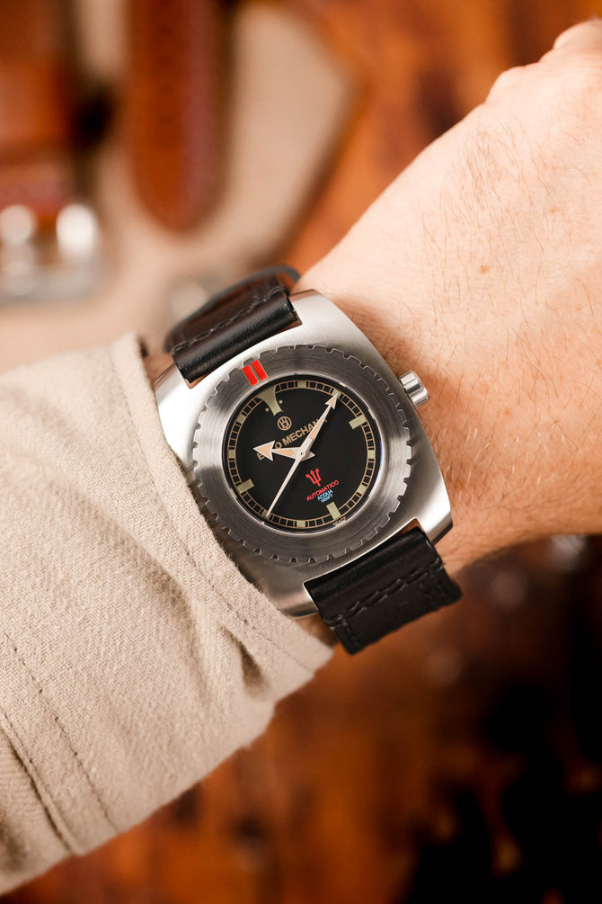 black dial watch (on wrist)