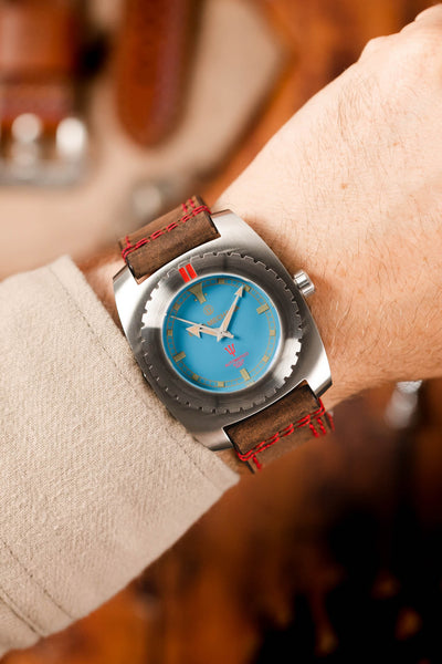 blue dial watch (on wrist)