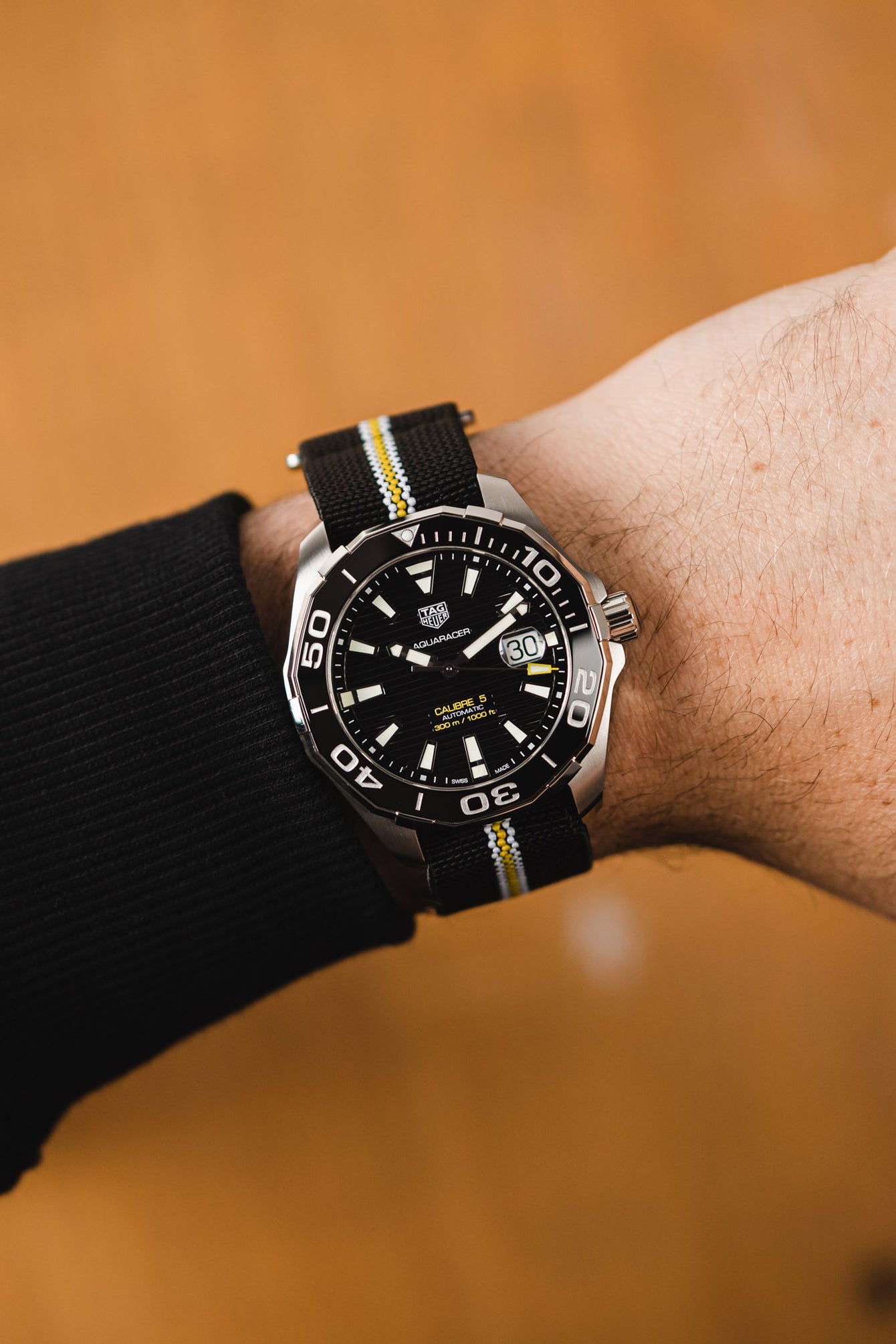 Tag Heuer Aqua Racer Black Dial 41mm fitted with Erika's Originals Corsa Strap with yellow centerline worn on wrist