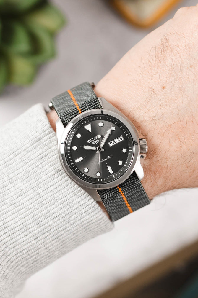 Seiko 5 sports anthracite dial SRPE51K1 fitted with Erika's Originals Mirage watchstrap with orange centerline on wrist