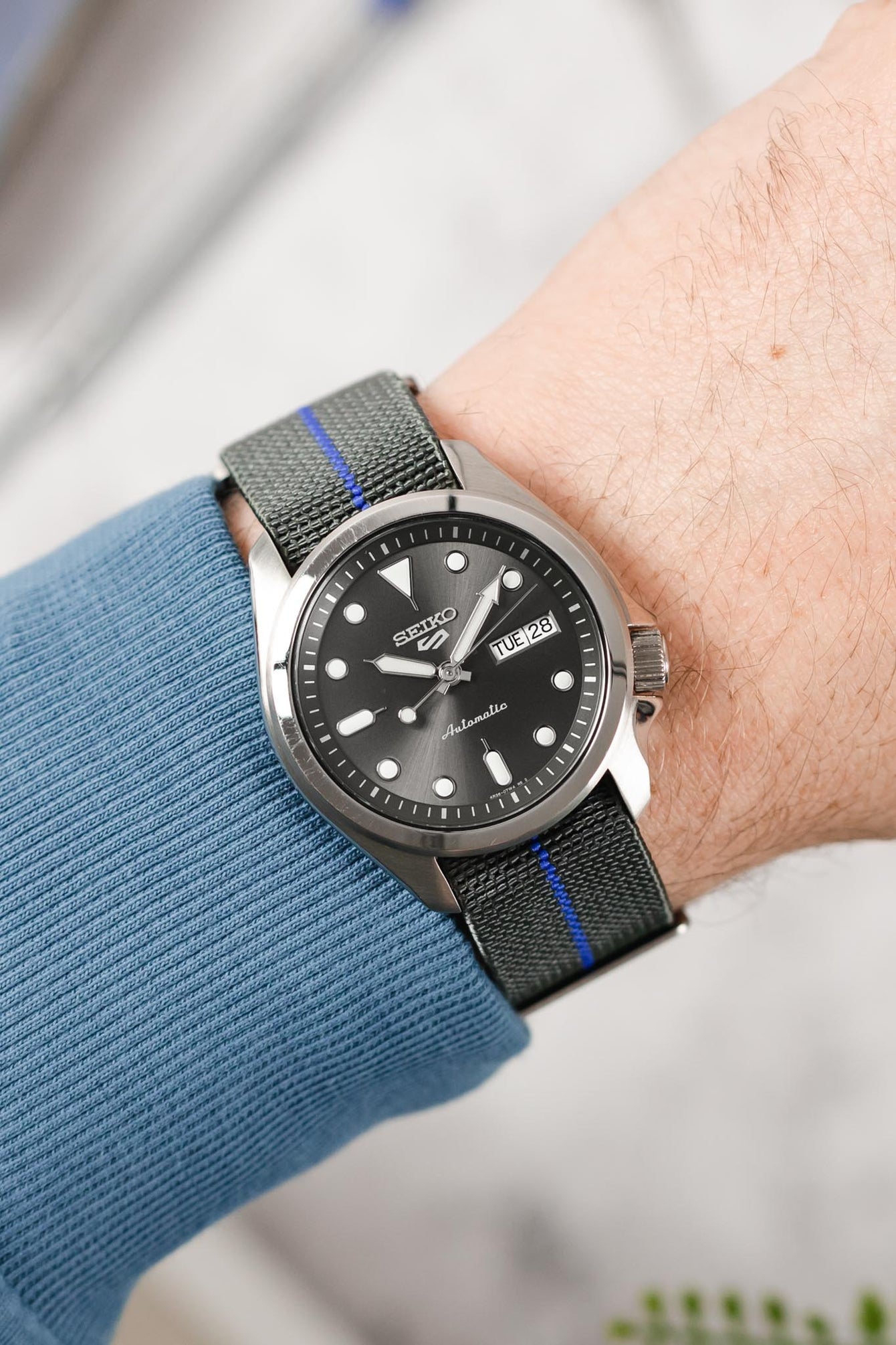Seiko 5 sports anthracite dial SRPE51K1 fitted with Erika's Originals Mirage watchstrap with royal blue centerline on wrist