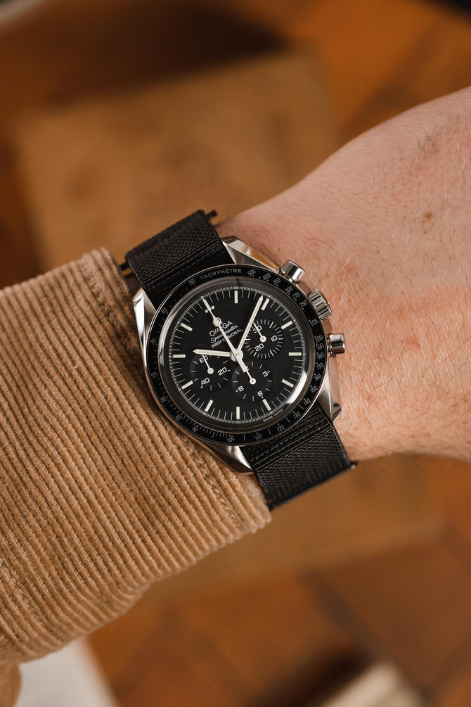 Speedmaster Moonwatch Professional black dial fitted with Erika's Originals NASA MN watch strap in full black on wrist