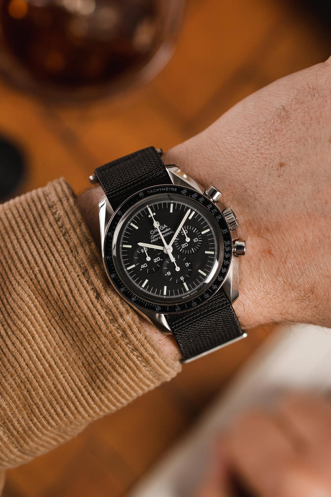 Speedmaster Moonwatch Professional black dial fitted with Erika's Originals NASA MN watch strap in full black on wrist 