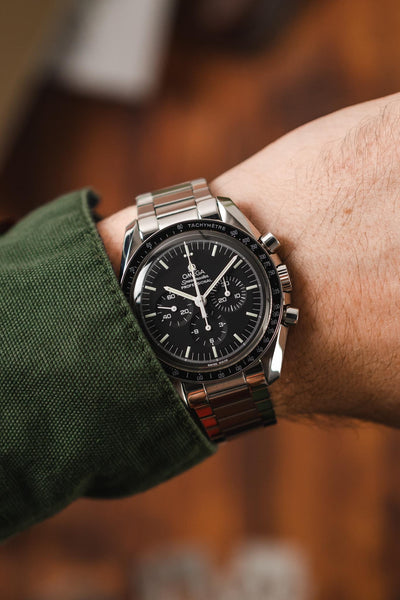 Omega Speedmaster Moonwatch Black Dial fitted with Forstner Flat Link watch bracelet in polished and brushed worn on wrist