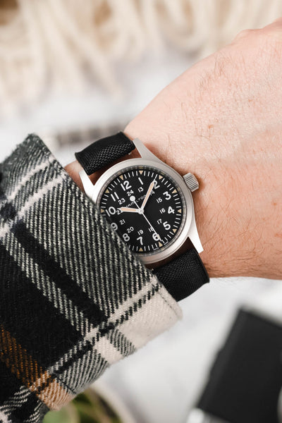 Hamilton Khaki Field watch fitted with Hirsch Arne Black Sailcloth effect watch strap worn on wrist