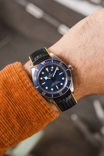 Tudor Black Bay 58 Blue fitted with Hirsch Ayrton Black and Yellow Carbon embossed watch strap worn on wrist 