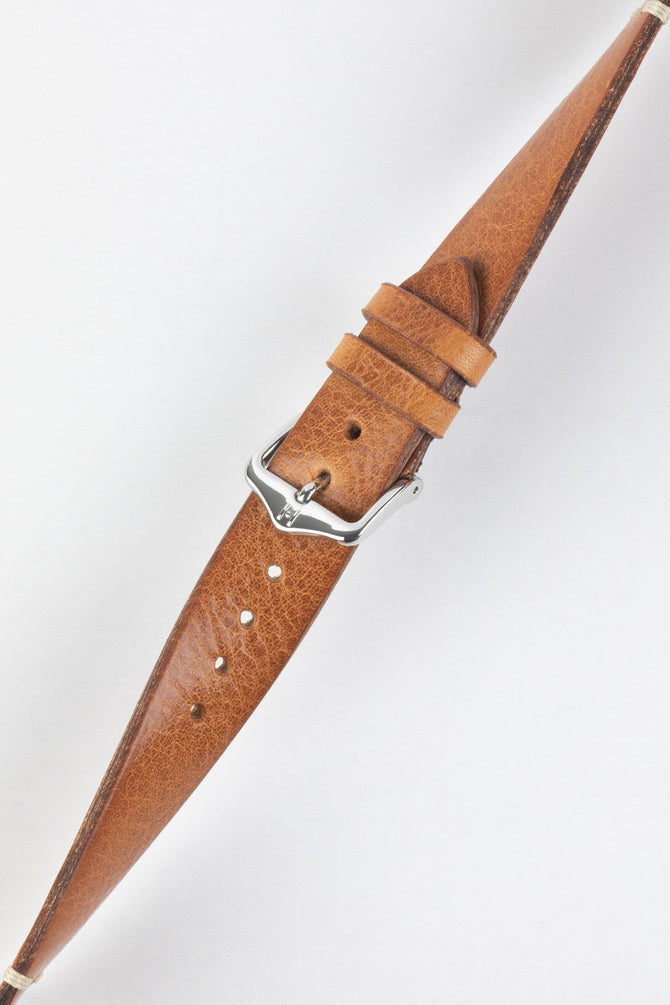 Hirsch Bagnore leather watch strap twisted to show vintage grain in the gold brown leather.
