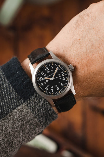 Hamilton Khaki Field watch fitted with Hirsch Camelgrain black leather strap worn on wrist