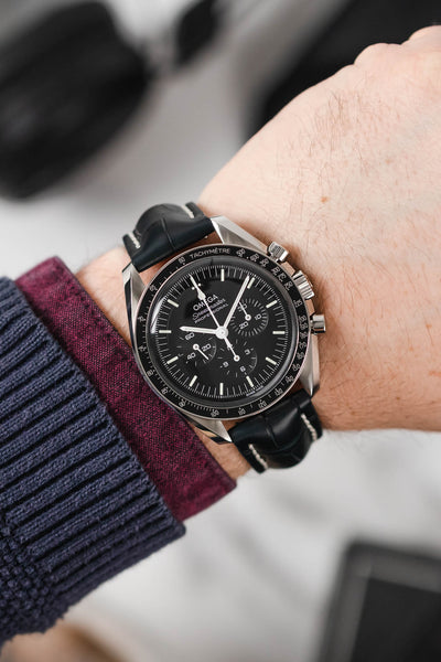 Black mega Speedmaster Moonwatch fitted with Hirsch Capitano blue leather strap worn on wrist