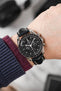 Black mega Speedmaster Moonwatch fitted with Hirsch Capitano blue leather strap worn on wrist
