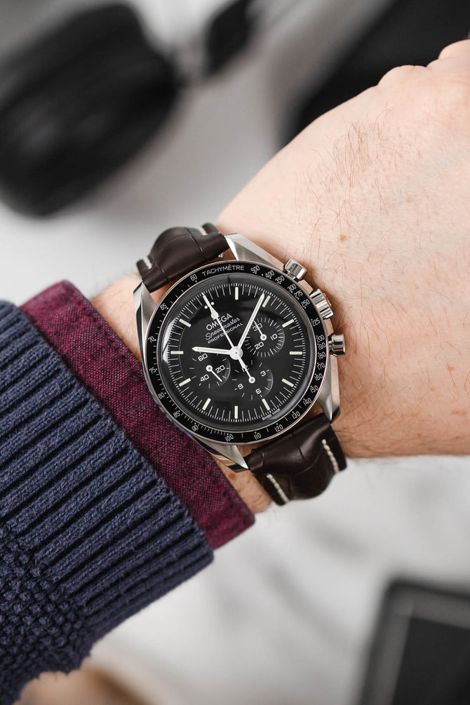 Black mega Speedmaster Moonwatch fitted with Hirsch Capitano brown leather strap worn on wrist
