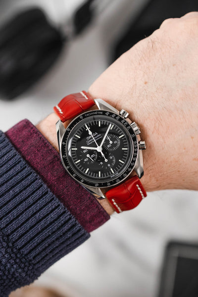 Black mega Speedmaster Moonwatch fitted with Hirsch Capitano red leather strap worn on wrist