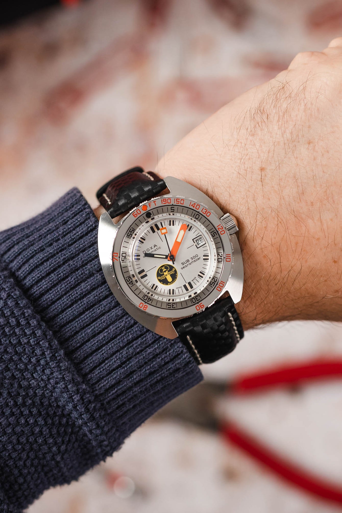 Doxa Sub 300 Aqua Lung fitted with Hirsch Carbon black leather watch strap worn on wrist