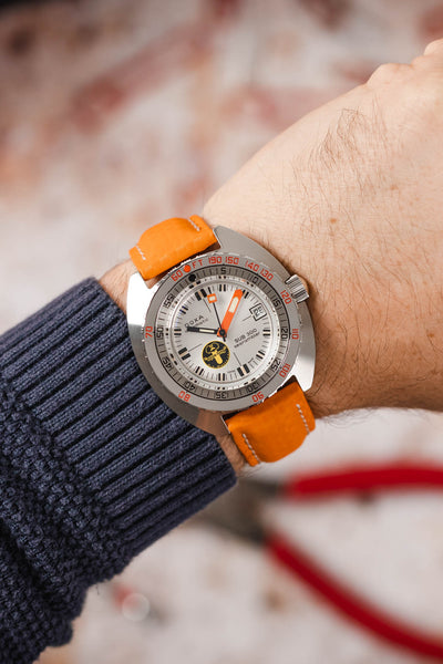 Doxa Sub 300 Aqua Lung fitted with Hirsch Carbon orange leather watch strap worn on wrist