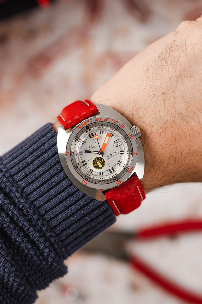 Doxa Sub 300 Aqua Lung fitted with Hirsch Carbon red leather watch strap worn on wrist