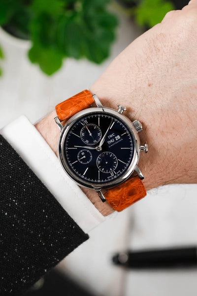IWC Portofino Chronograph fitted with Hirsch Genuine Crocodile orange leather watch strap worn on wrist