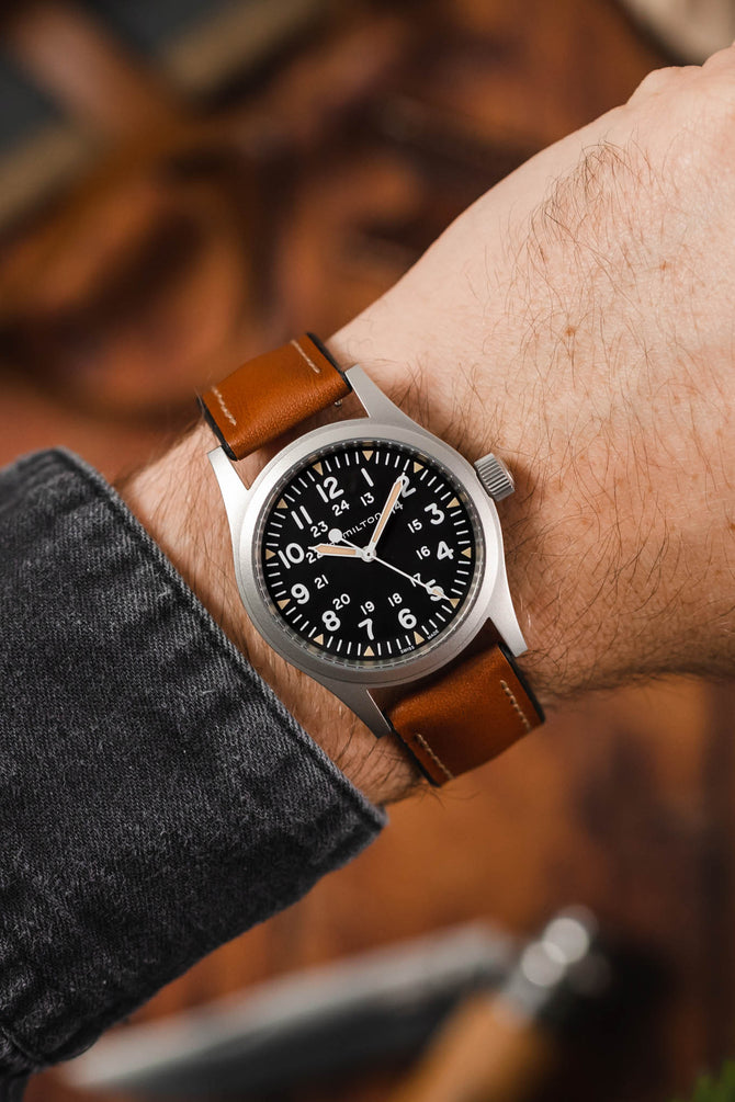 Hamilton Khaki field watch fitted with Hirsch James gold brown leather watch strap worn on wrist