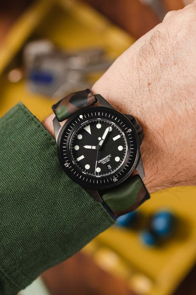 Black Unimatic U1 fitted with Hirsh John Camo green Rubber watch strap worn on wrist