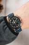 Black Omega Speedmaster Moonwatch fitted with Hirsch Leaf Vegan Rubber blue and black watch strap worn on wrist