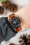 Black Omega Speedmaster Moonwatch fitted with Hirsch Leaf Vegan Rubber brown watch strap worn on wrist