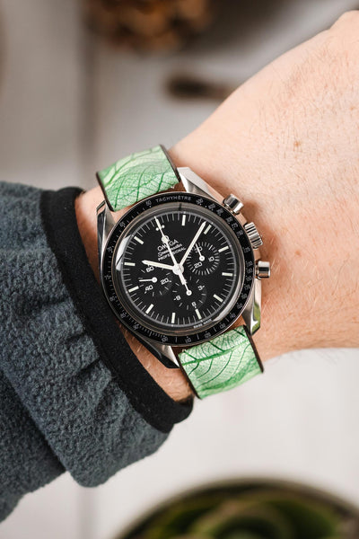 Black Omega Speedmaster Moonwatch fitted with Hirsch Leaf Vegan Rubber green watch strap worn on wrist