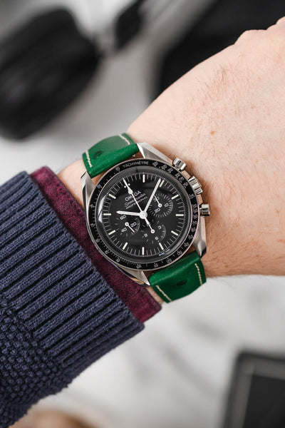 Black Omega Moonwatch Speedmaster fitted with Hirsch Massai Ostrich green with white stitch leather watch strap worn on wrist