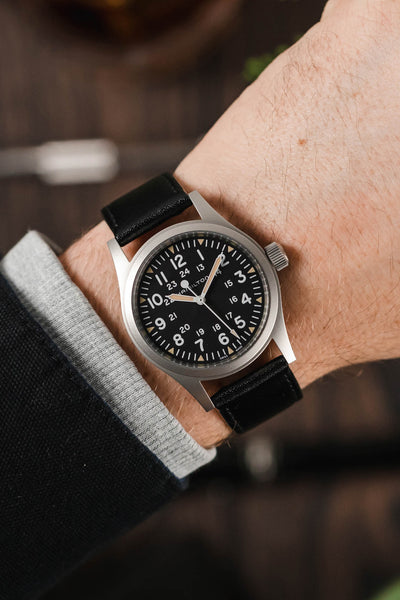 Hamilton Khaki Filed watch fitted with Hirsch Osiris Black leather watch strap worn on wrist
