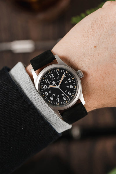 Hamilton Khaki Filed watch fitted with Hirsch Osiris Black leather watch strap worn on wrist