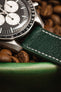 dark green leather watch strap with white stitching