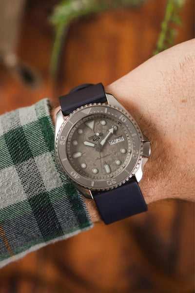 Bonetto Cinturini Dark Blue 270 fitted to Seiko 5 Sports SRPG61K1 cement dial on wrist with flannel shirt