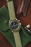 Omega Speedmaster gold bezel black dial fitted with Di-modell Natural watch strap in Green